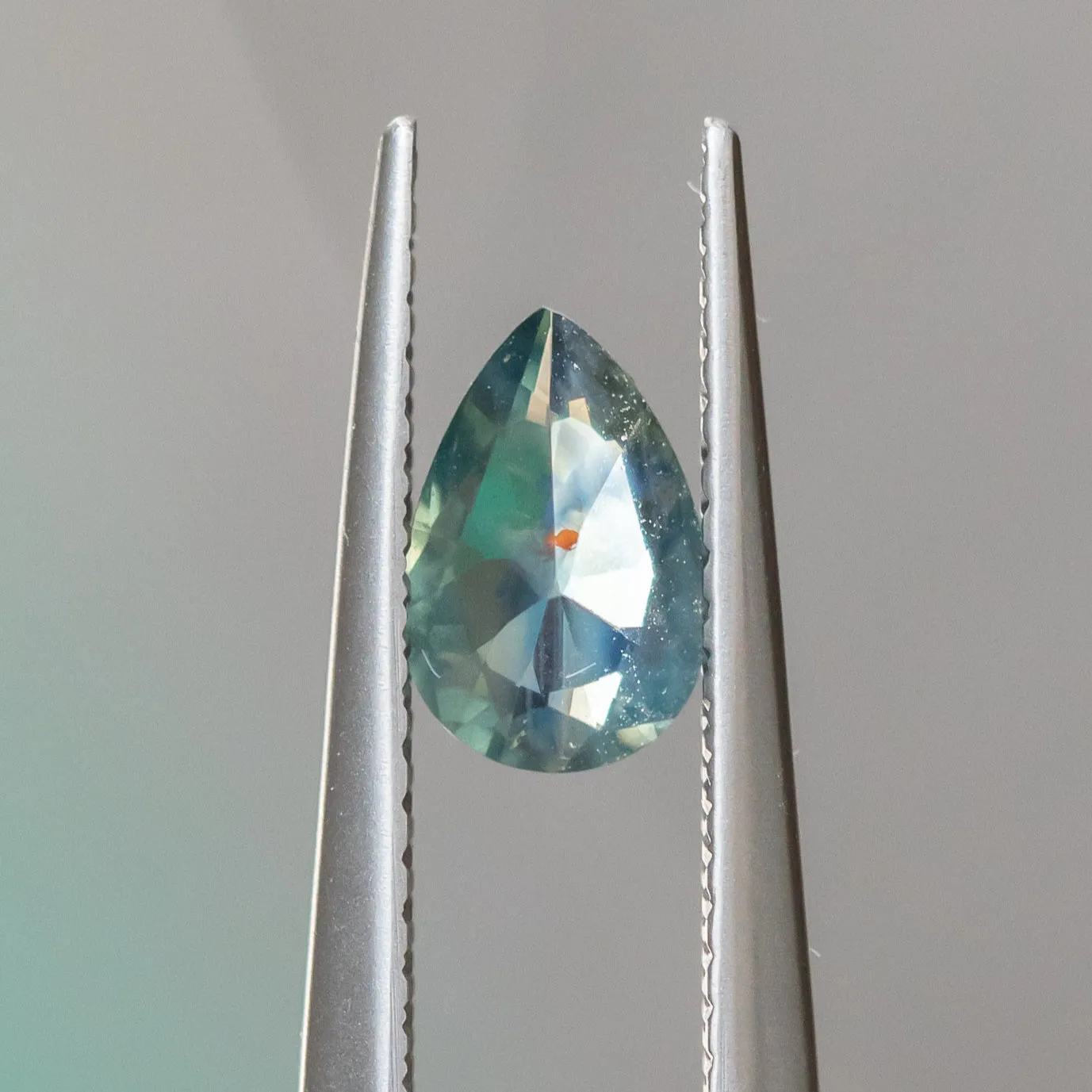 0.74CT PEAR SAPPHIRE, SILKY TEAL WITH ORANGE INCLUSION, 7.43X4.9MM